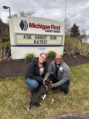 Michigan First team members petting an adoptable puppy in Grand Rapids!